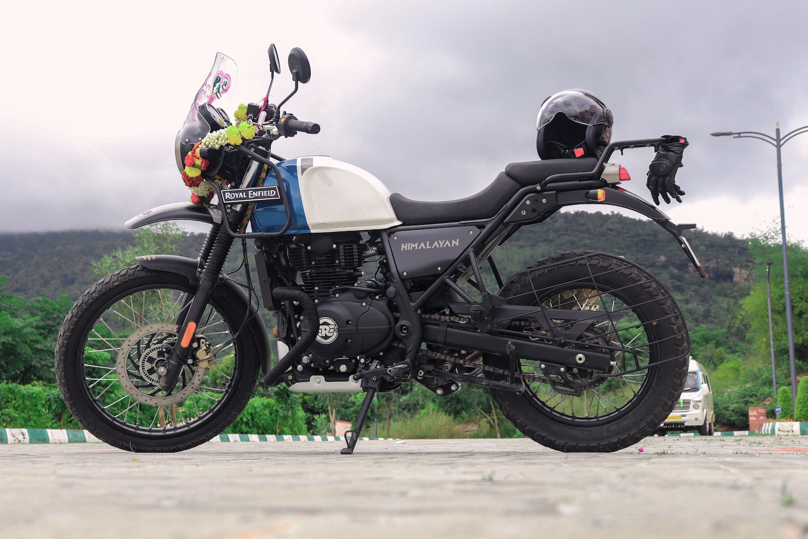 man riding on white and black motorcycle