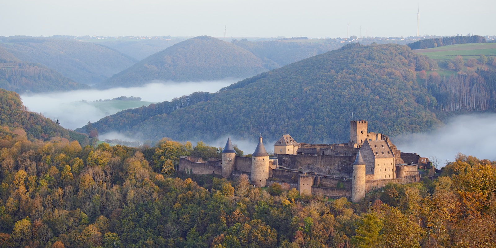 brown concrete castle on top of mountain during daytime